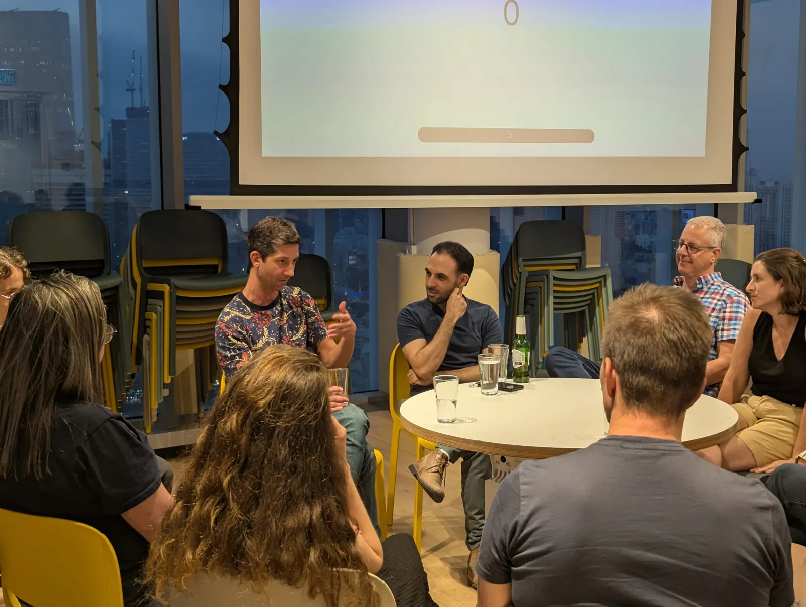 PMM Collective members talking in a circle at a meetup