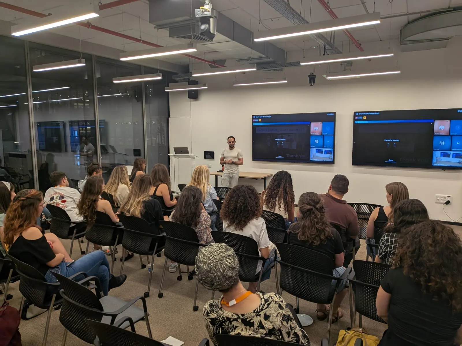 A PMM101 lecture: a full room of product marketers facing the speaker