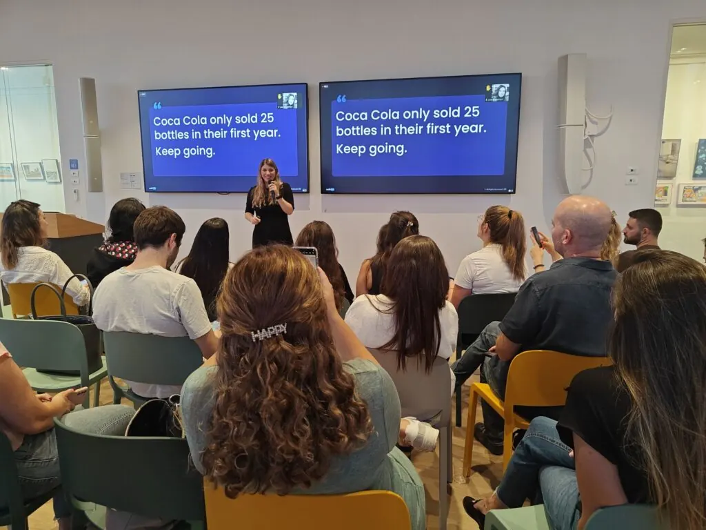 A PMM101 lecture: a speaker presenting to a full room of product marketers